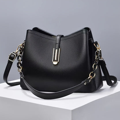 Elegant black crossbody bag with adjustable strap and gold hardware