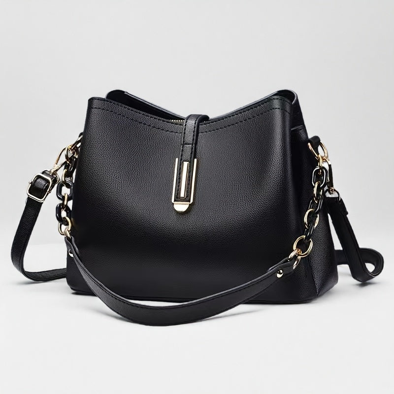 Elegant black crossbody bag with adjustable strap and gold hardware