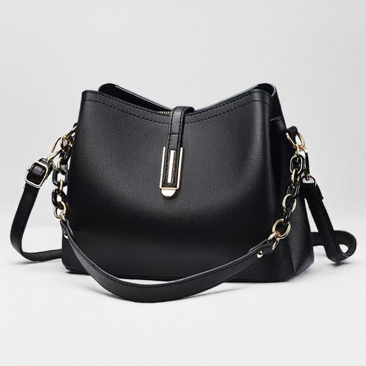 Elegant black crossbody bag with adjustable strap and gold hardware